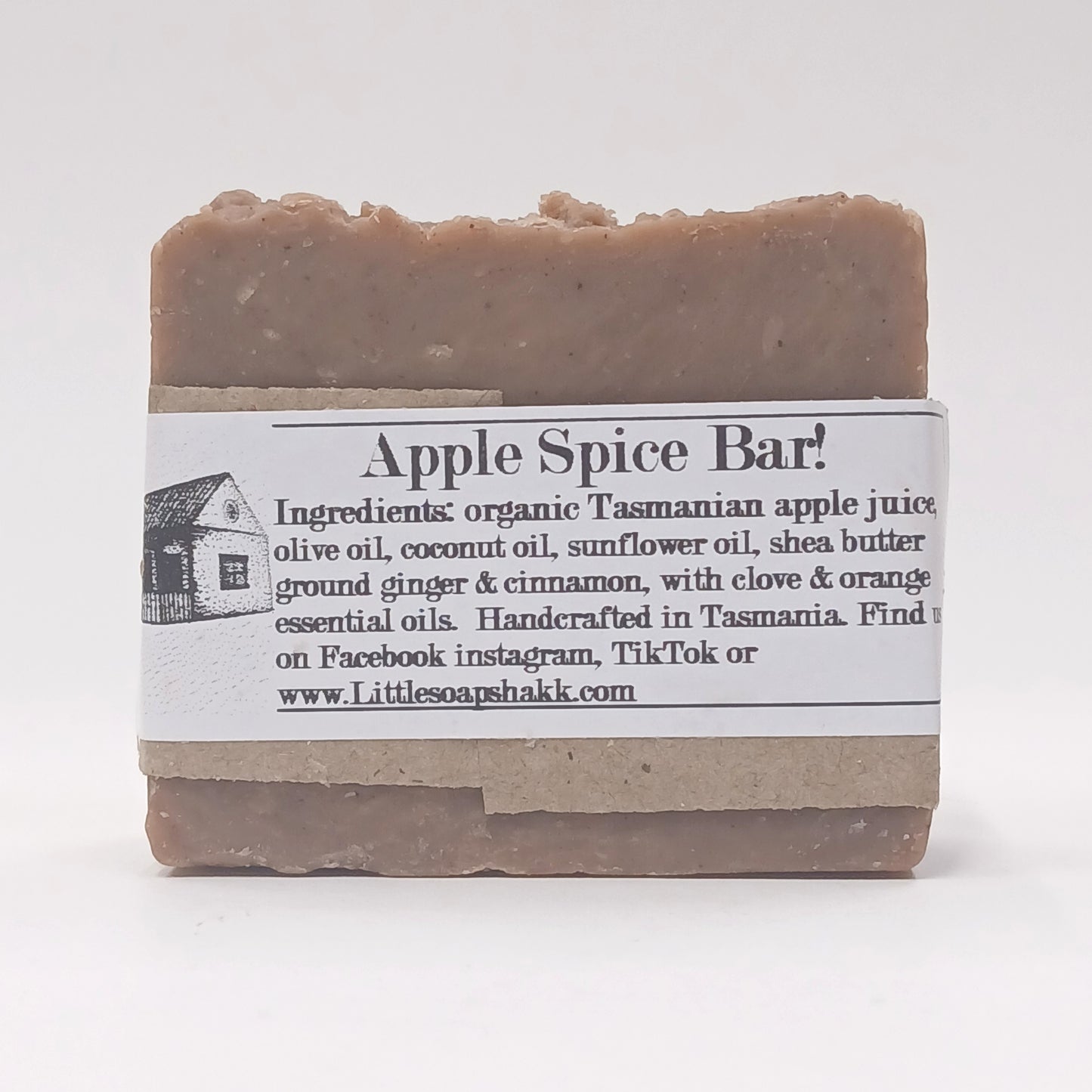 Bar of soap with an label detailing ingredients and branding on a white background