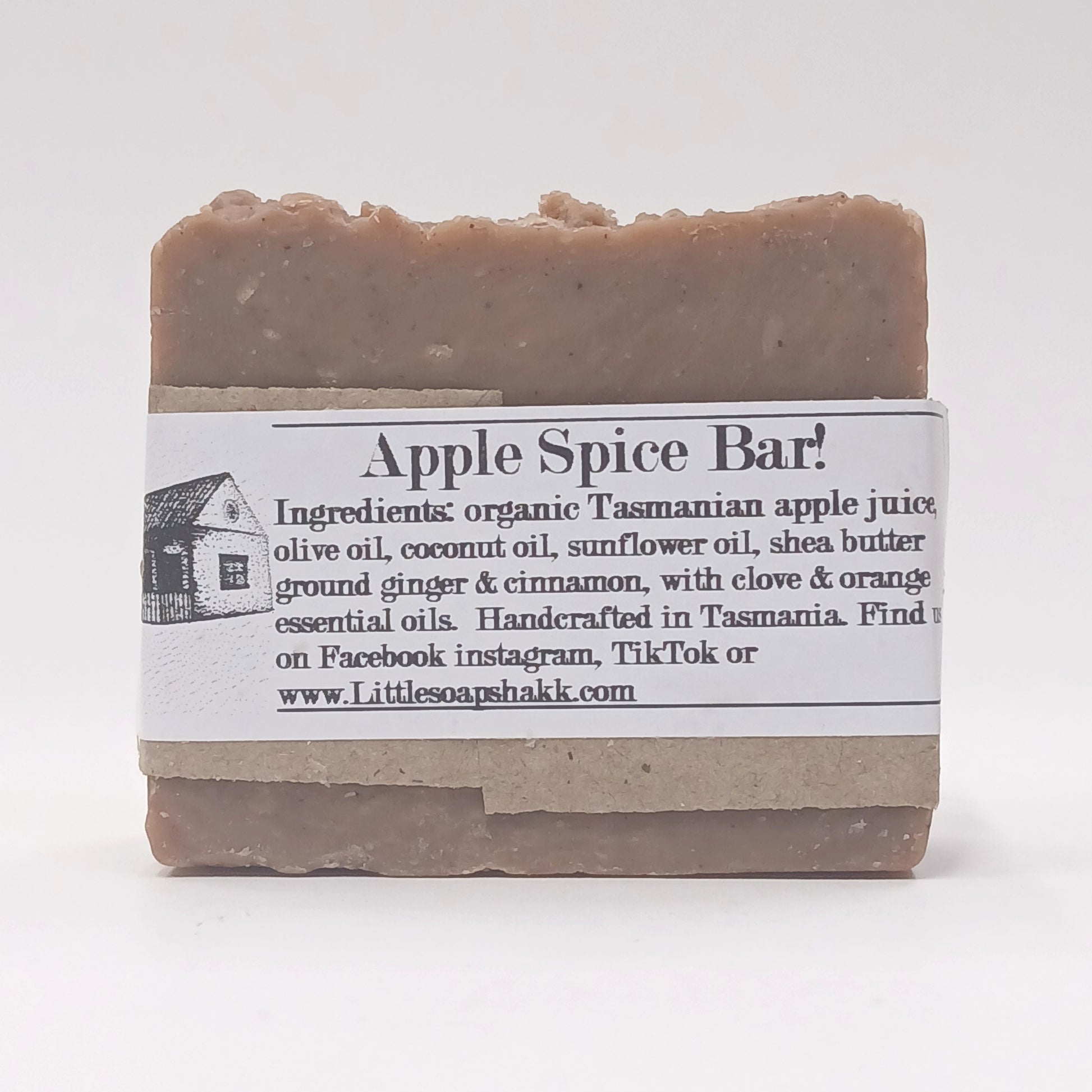 Bar of soap with an label detailing ingredients and branding on a white background