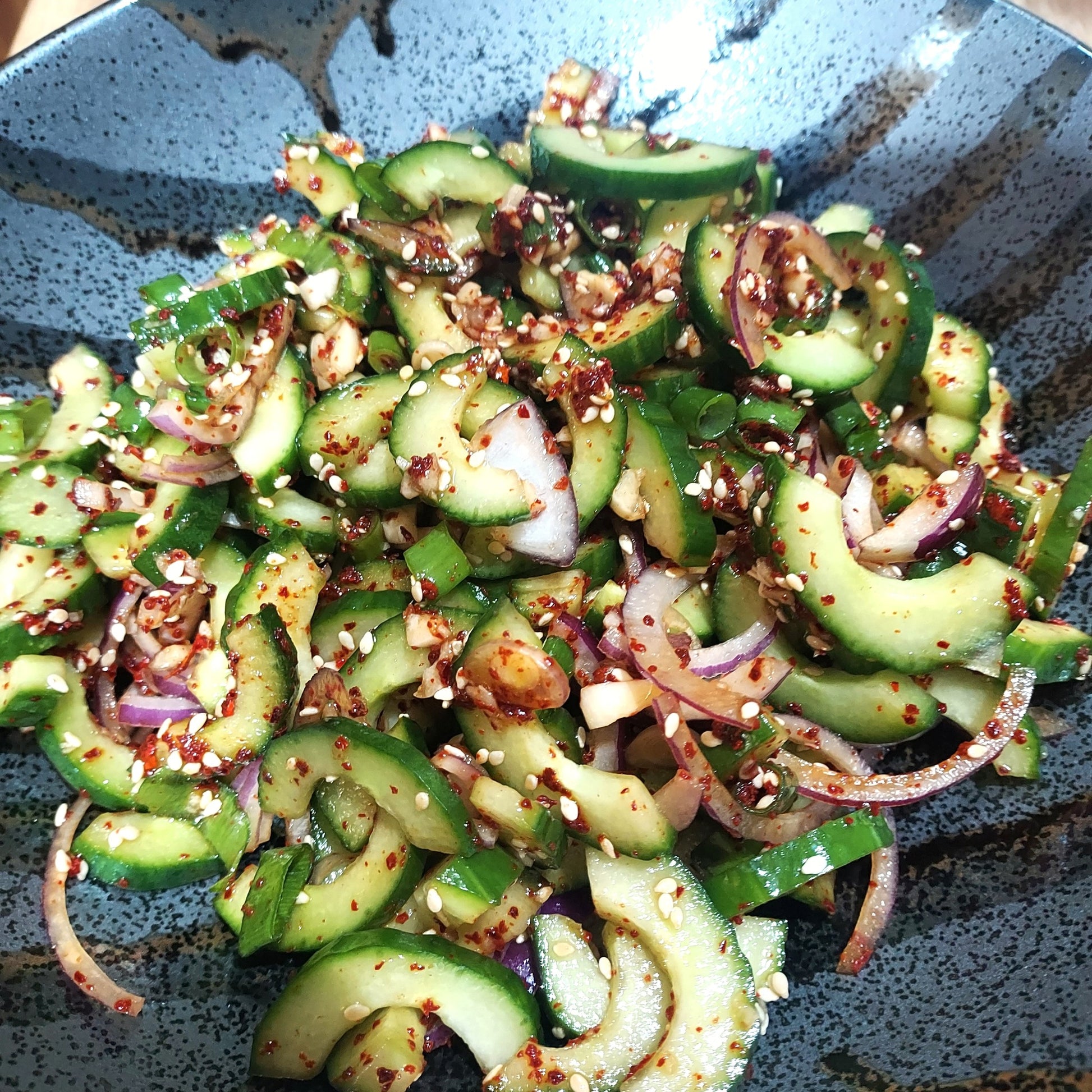 Sliced and seaded lebanese cucumbers mixed with sesame chilli condiment for a spicy fresh salad