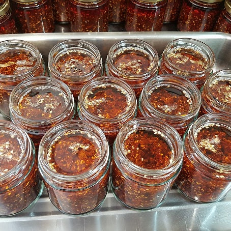 freshly made batch of range Tasmania sesame chilli condiment in jars