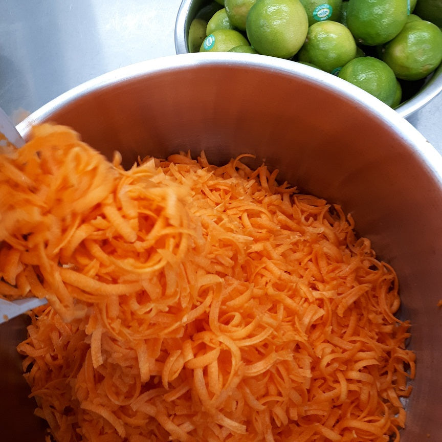 juicy Tasmanian carrots being grated and a bowl of fresh limes ready for making range tasmania carrot and lime jam