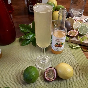 tall glass of sparking white wine with range Tasmania passionfruit cordial and fresh passionfruit